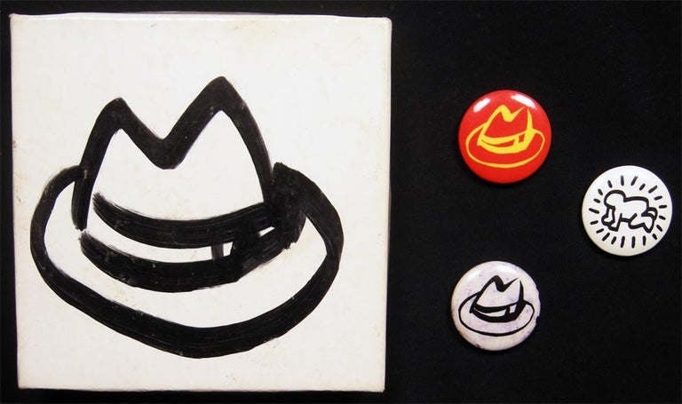 Item #028394 Tom Slaughter Hat Illustrated 1" Pin-Back Buttons in Hat Box (with) Keith Haring Button. Art - 20th Century - Tom Slaughter - Keith Haring.
