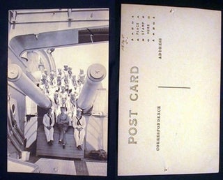 Item #15765 Real Photo Postcard of US Navy Personnel Sitting on Gun Carriage of Ship. World War II