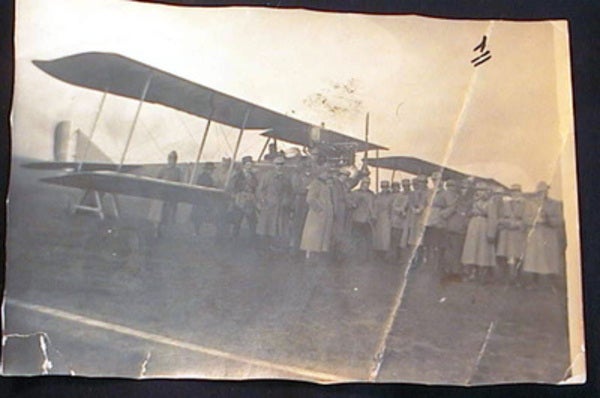 Item #18277 Snapshot of an Early Twentieth-Century Biplane with Military Personnel. Aviation.