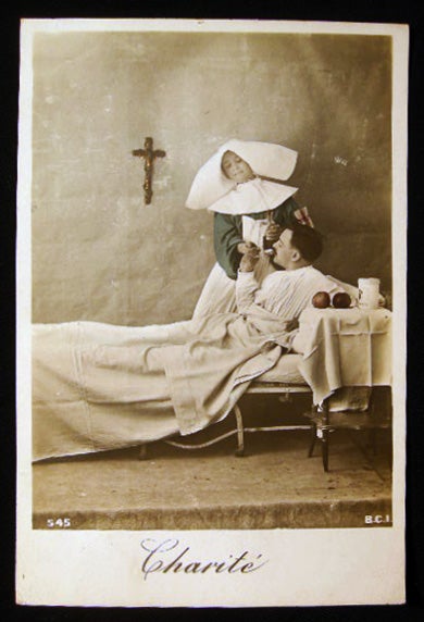 Item #24445 Circa 1916 "Charite" Real Photo Postcard with Hand Coloring & Gold Highlights of a French Nursing Sister Giving a Patient Medicine. France - Photography - Nursing - Real Photo Postcard.