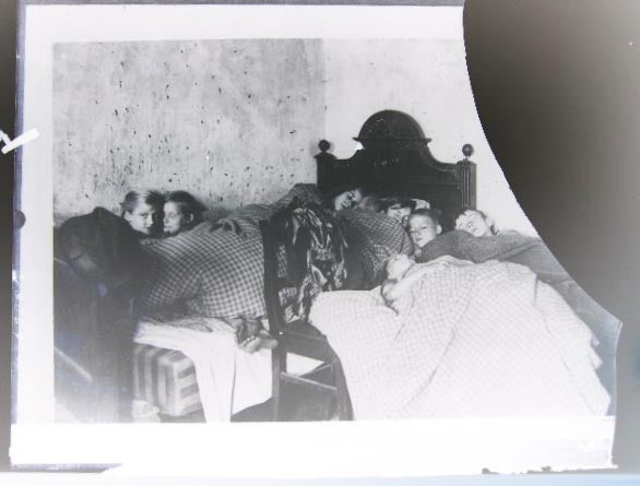 Item #24569 Circa 1920 Glass Plate Negative Photograph of Conditions in Germany Eight Children of Berlin Sleeping in One Room, on a Bed Made of a Broken Bedstead...by Keystone View Co. Photography - 20th Century - Germany - Berlin - Social Conditions Post World War I.